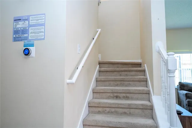 a view of a patio with a table and chairs under an umbrella