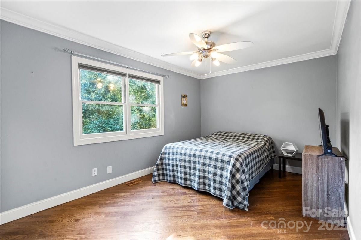 7918 Sarah Drive Denver, NC 28037 - Photo 13 of 31 a bedroom with a bed and wooden floor