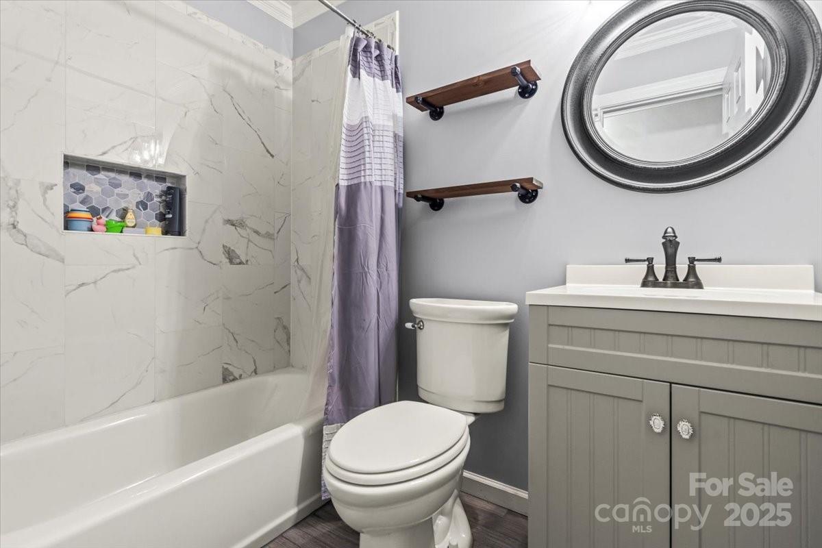 7918 Sarah Drive Denver, NC 28037 - Photo 18 of 31 a bathroom with a sink a mirror and a toilet