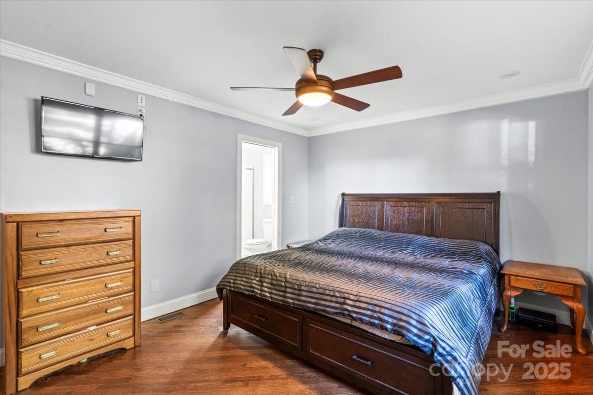 7918 Sarah Drive Denver, NC 28037 - Photo 21 of 31 a bedroom with a bed and a dresser