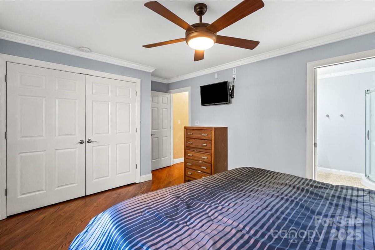 7918 Sarah Drive Denver, NC 28037 - Photo 22 of 31 a bedroom with a bed and a flat screen tv