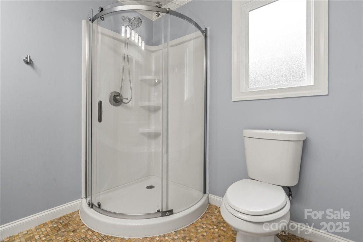 7918 Sarah Drive Denver, NC 28037 - Photo 23 of 31 a bathroom with a toilet and a shower