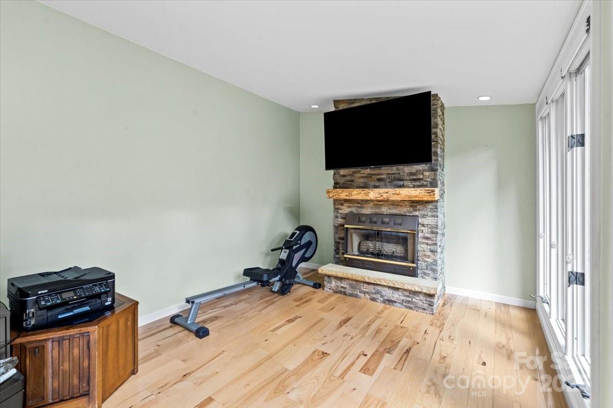 7918 Sarah Drive Denver, NC 28037 - Photo 26 of 31 a living room with a flat screen tv and a fireplace