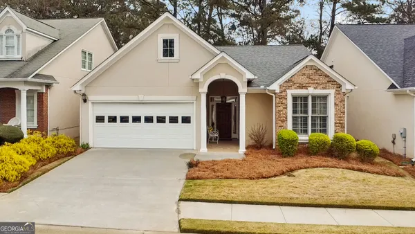 a front view of a house with garden