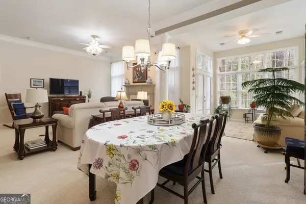 a view of a dining room with furniture and a chandelier