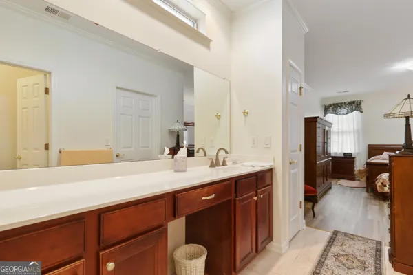 a en suite bathroom with a sink double vanity and a mirror