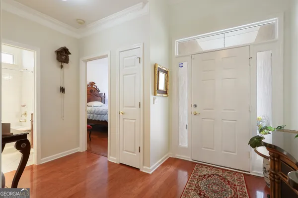 an empty room with wooden floor and closet