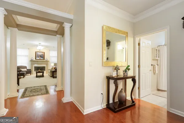 a view of a hallway with a livingroom and couch