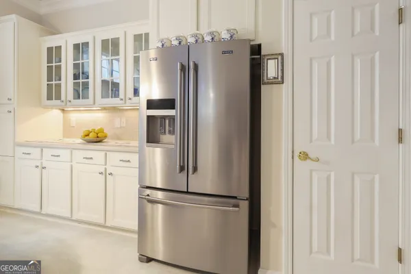 a white refrigerator freezer and a stove sitting inside of a kitchen
