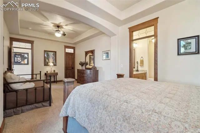 a living room with furniture large windows and wooden floor
