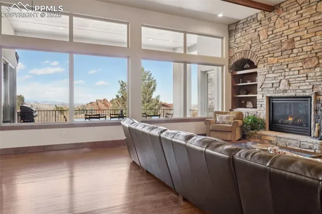 a kitchen with stainless steel appliances granite countertop a sink a stove and a wooden floors