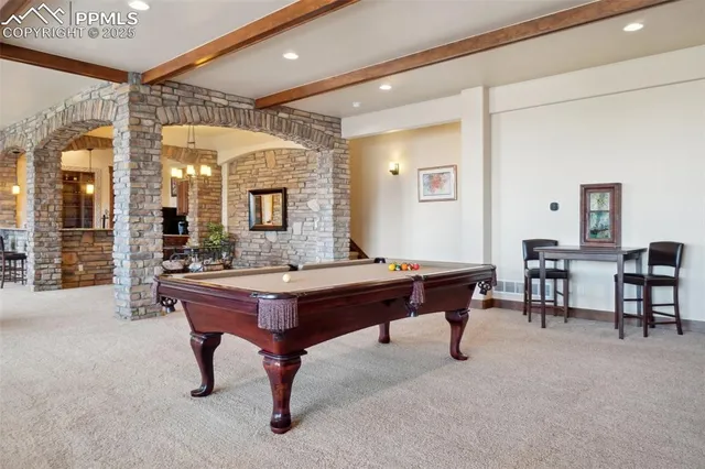 a spacious bedroom with a large bed and a fireplace