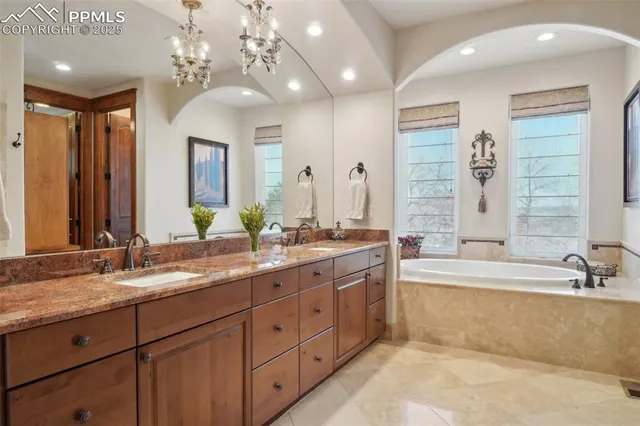 a spacious bathroom with a granite countertop sink and a mirror