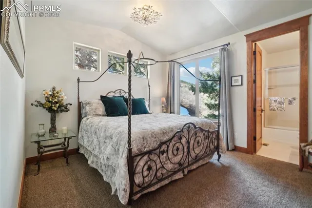 a bathroom with a granite countertop toilet sink and mirror