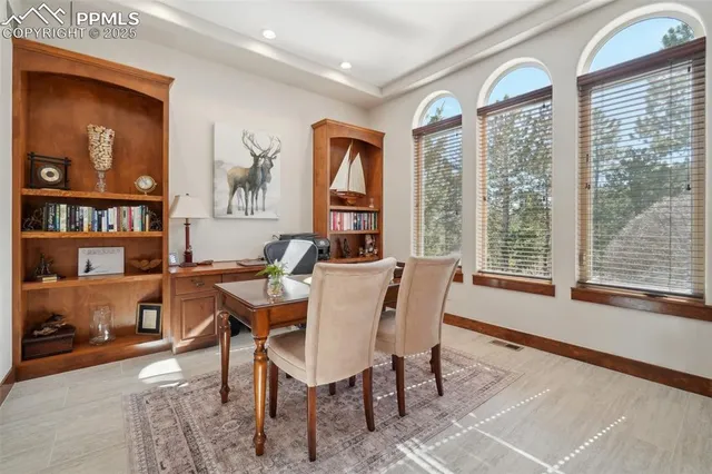a dining room with furniture and window