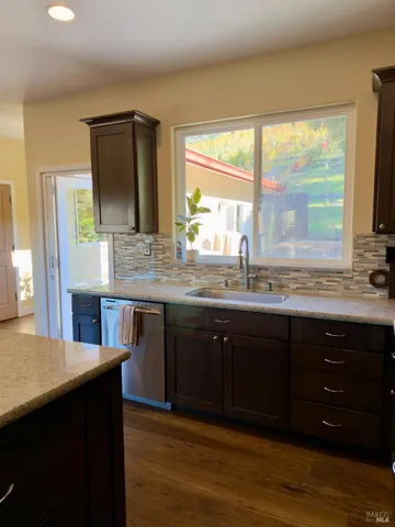 a kitchen with a sink and a large window