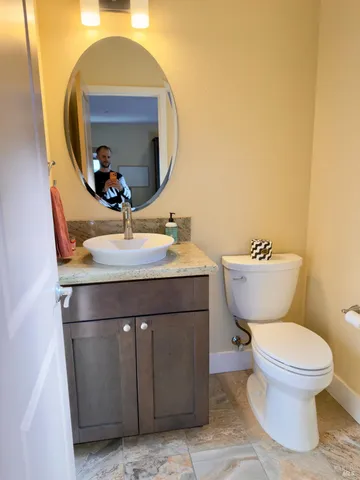 a bathroom with a toilet sink and mirror