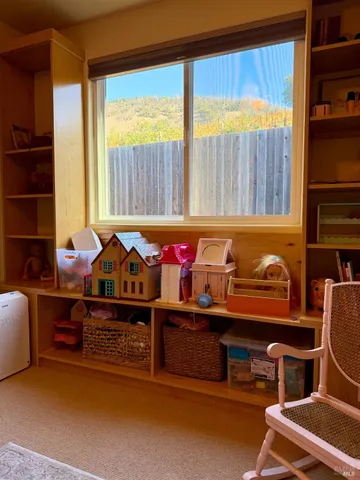 a room with furniture pool table and window