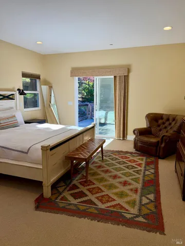 a bedroom with furniture and a large window