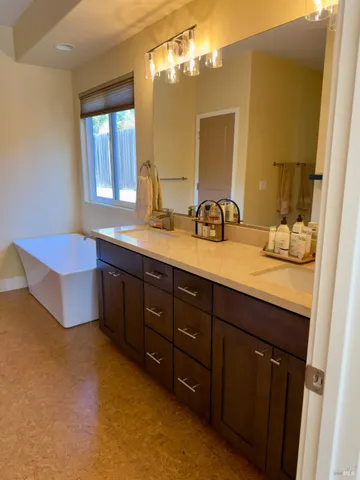 a bathroom with a double vanity sink and a mirror