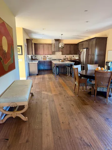 a living room with lots of furniture and kitchen view