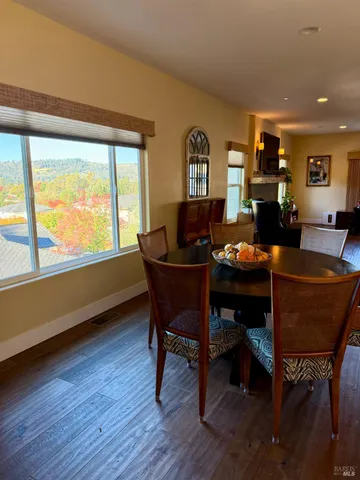 a dining room with furniture and wooden floor