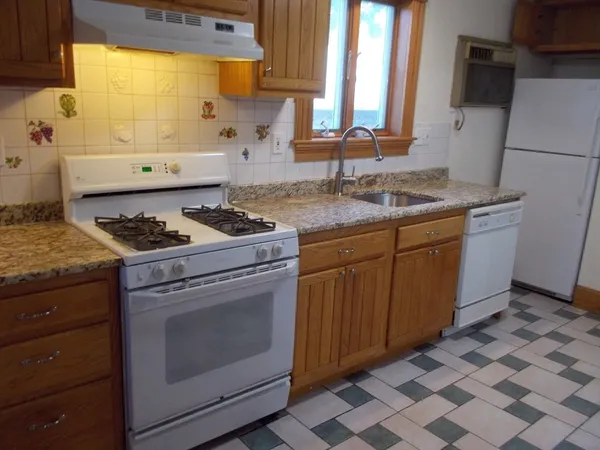 a kitchen with granite countertop cabinets and window