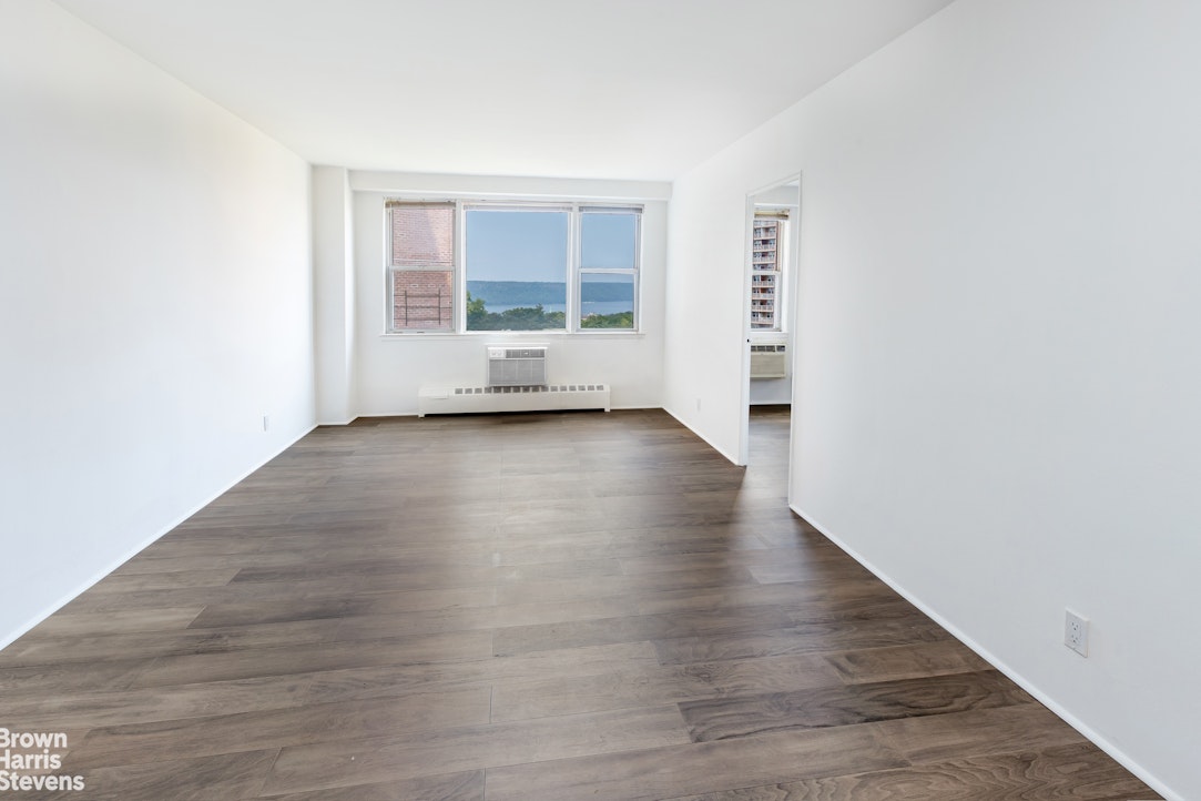 5700 Arlington Avenue, Unit 11X Bronx, NY 10471 - Photo 16 of 21 an empty room with wooden floor and windows
