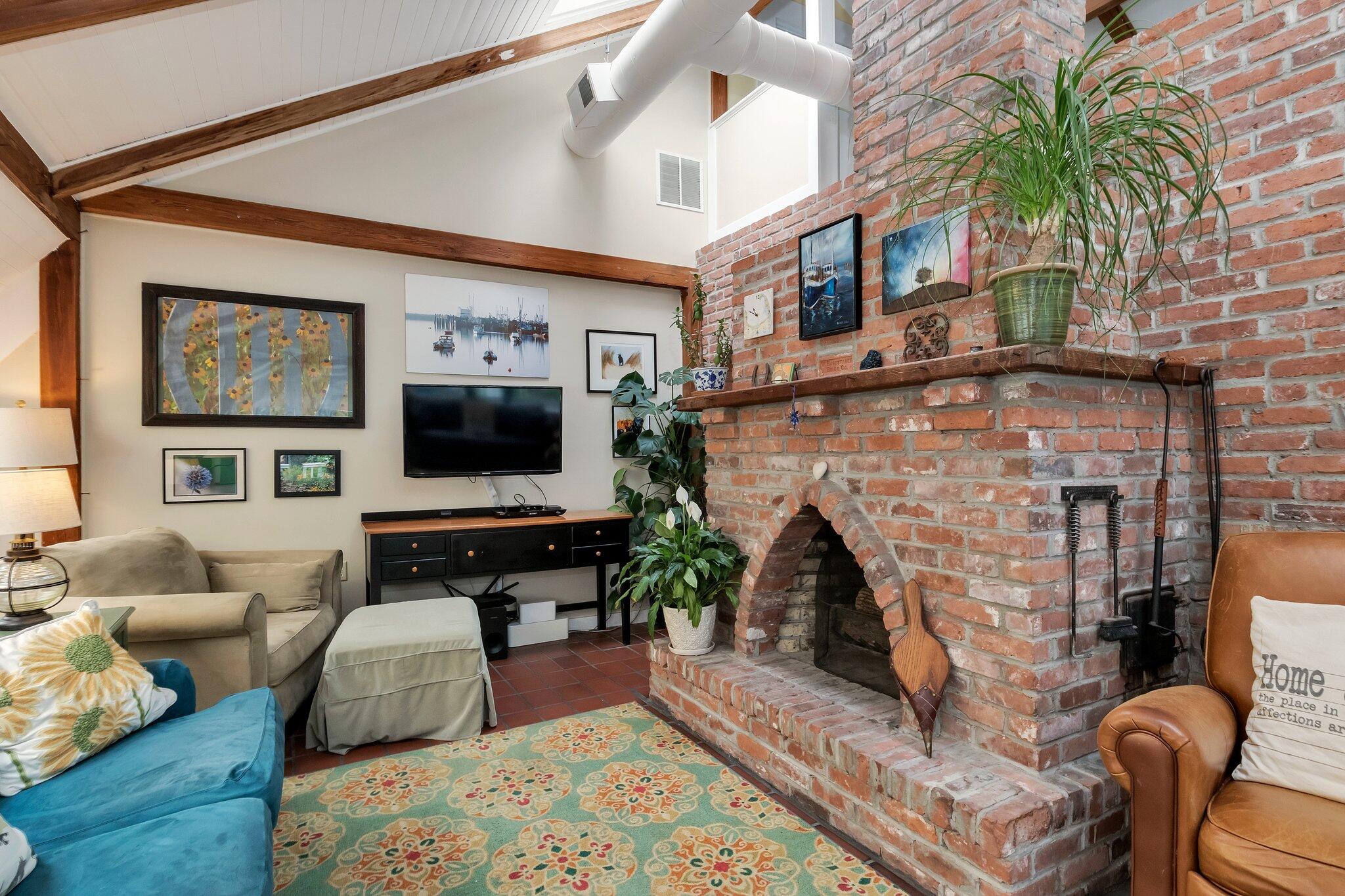 36 Bakers Pond Road Orleans, MA 02653 - Photo 14 of 50 a living room with furniture a flat screen tv and a fireplace
