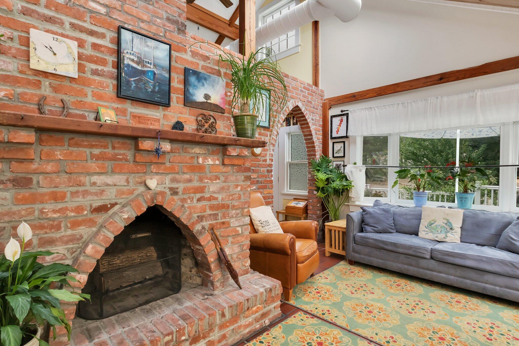 36 Bakers Pond Road Orleans, MA 02653 - Photo 16 of 50 a living room with furniture and a fireplace