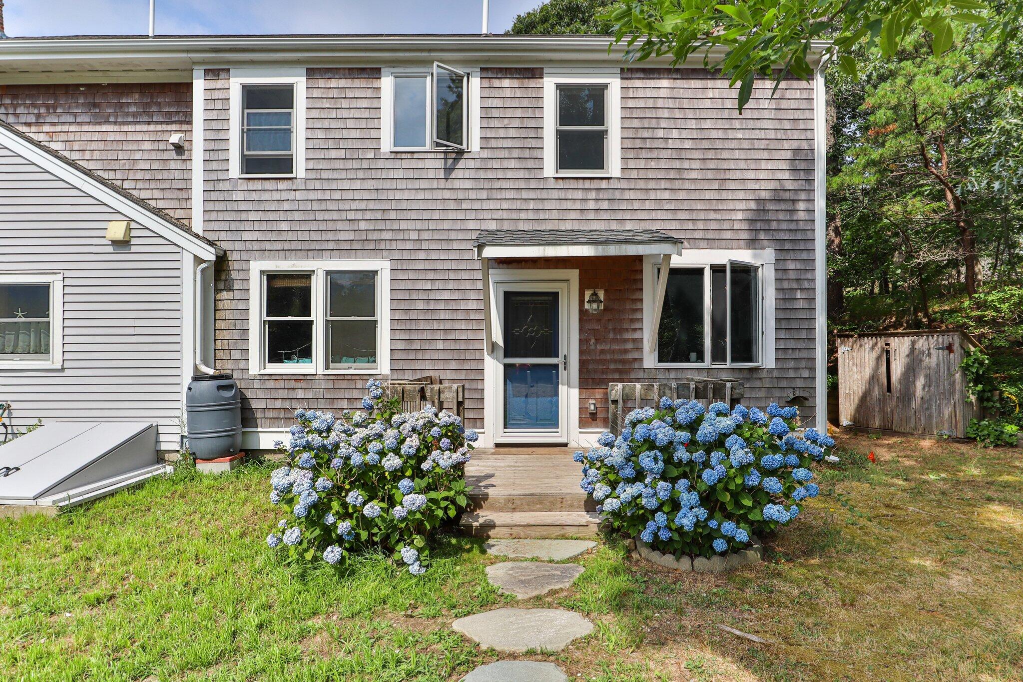 36 Bakers Pond Road Orleans, MA 02653 - Photo 23 of 50 a front view of a house with garden