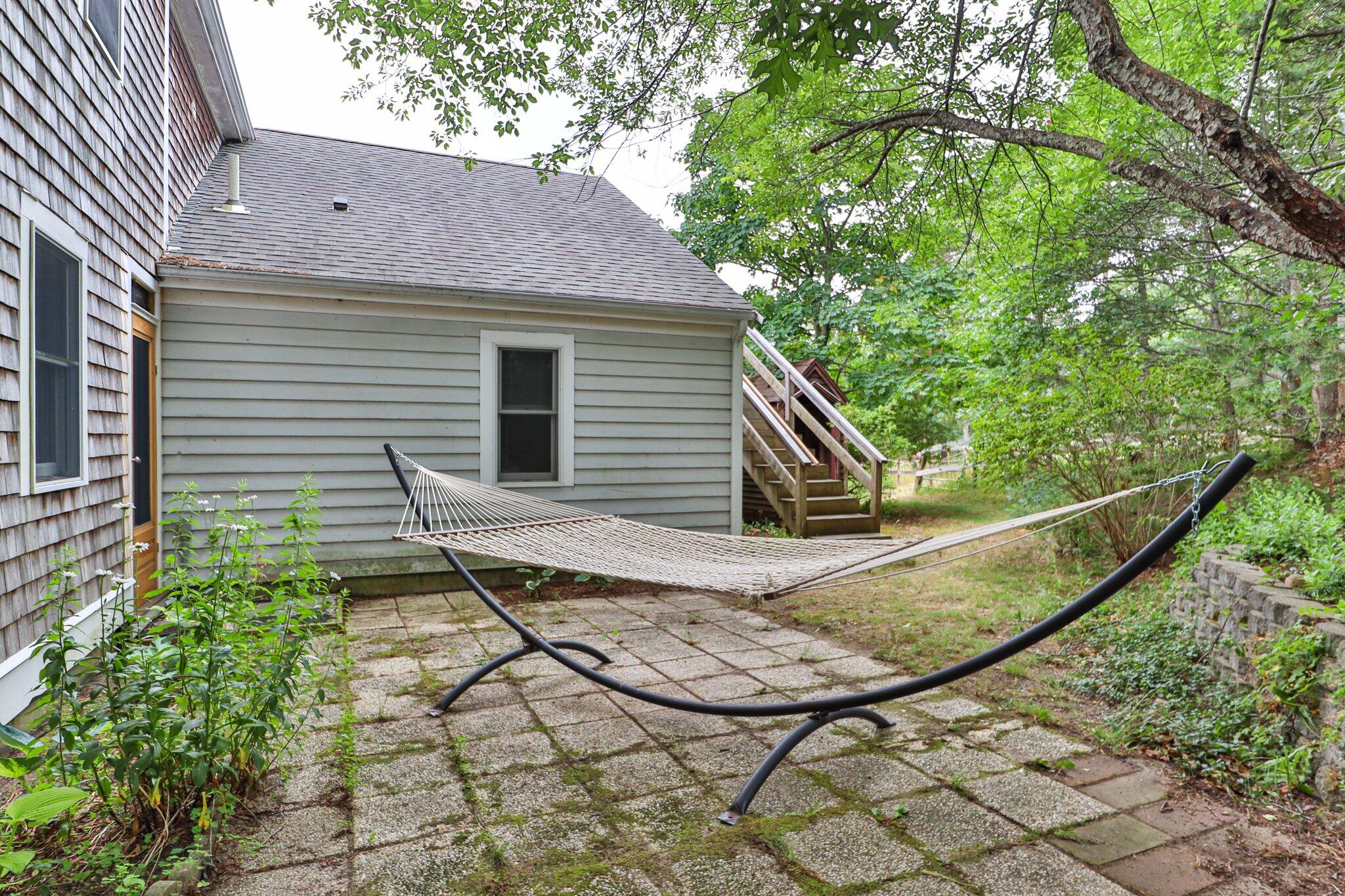 36 Bakers Pond Road Orleans, MA 02653 - Photo 29 of 50 a view of a house with a small yard plants and large tree