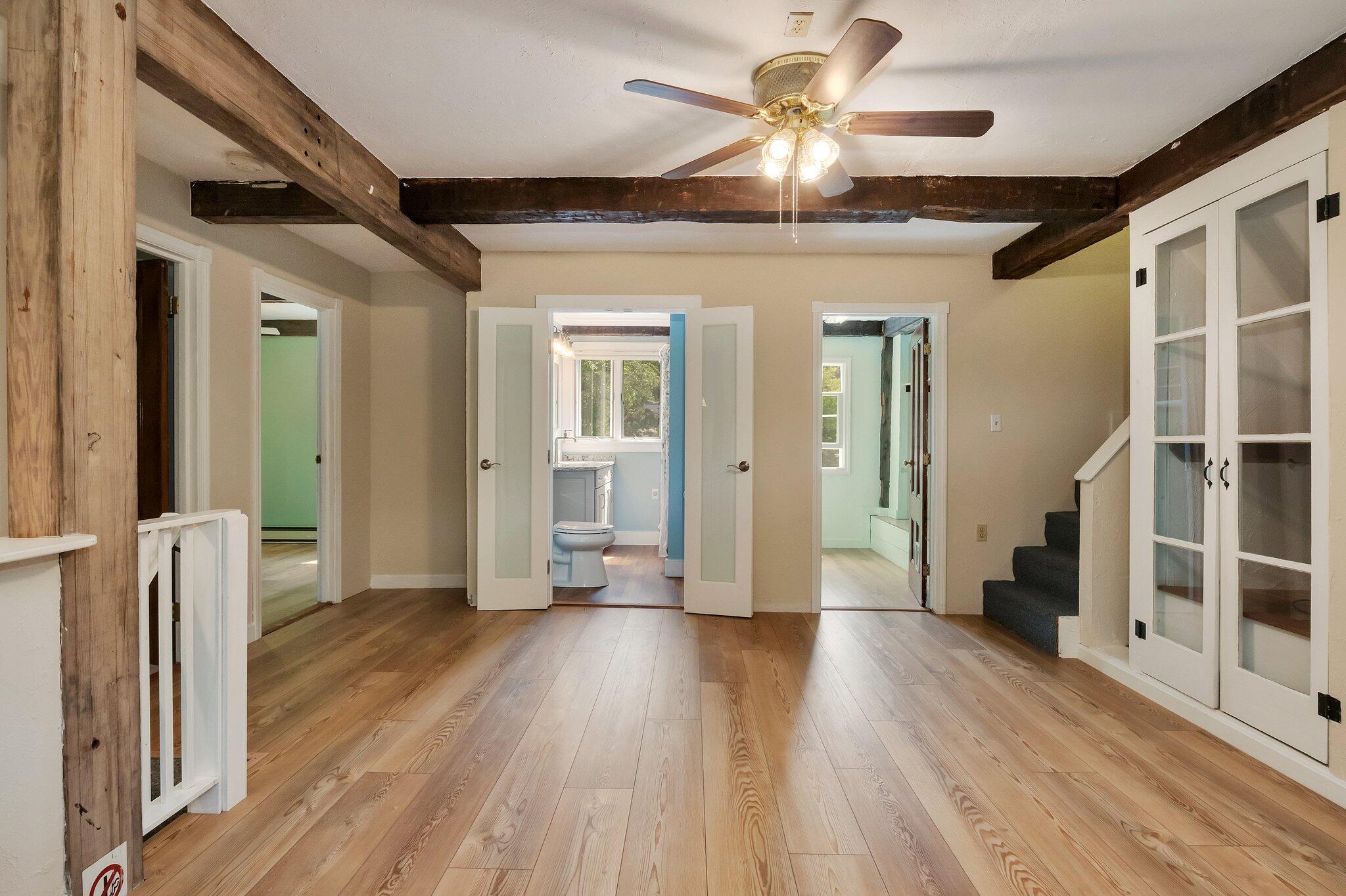 36 Bakers Pond Road Orleans, MA 02653 - Photo 32 of 50 a view of a hallway with wooden floor and a ceiling fan