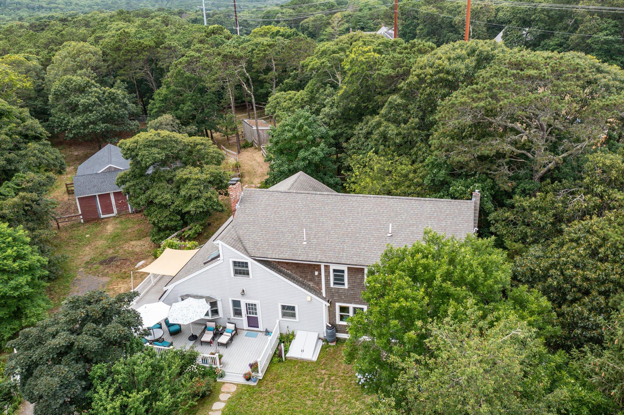 36 Bakers Pond Road Orleans, MA 02653 - Photo 38 of 50 an aerial view of a house with yard and trees in the background