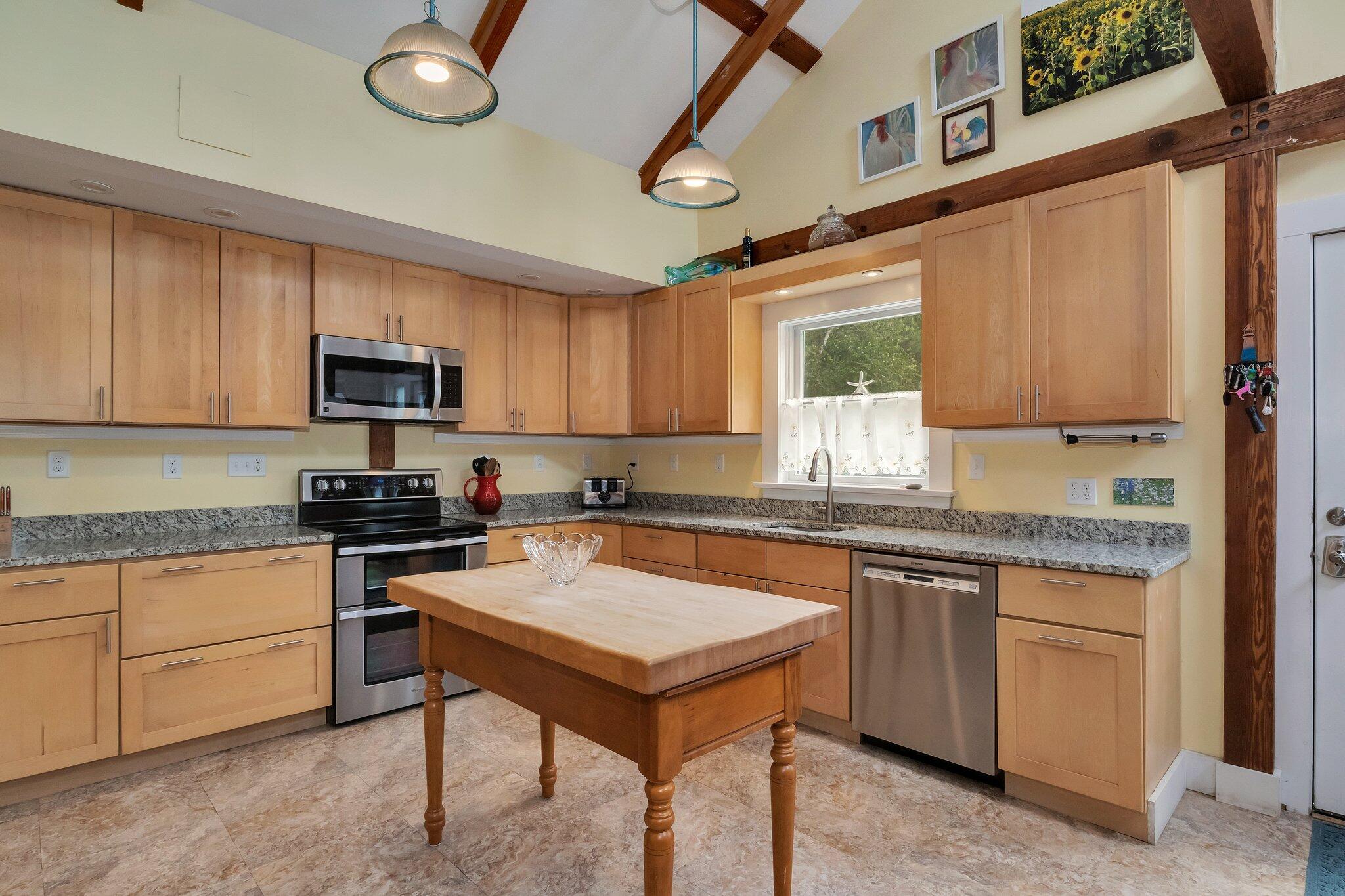 36 Bakers Pond Road Orleans, MA 02653 - Photo 8 of 50 a kitchen with stainless steel appliances granite countertop a stove top oven a sink dishwasher and a microwave oven on the blue kitchen countertops