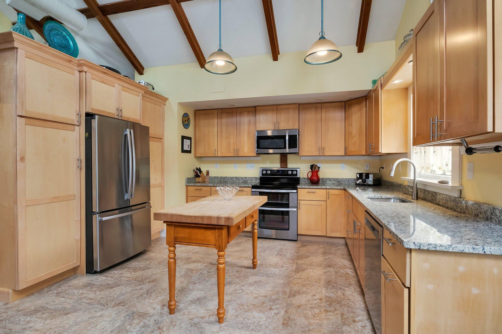 36 Bakers Pond Road Orleans, MA 02653 - Photo 9 of 50 a kitchen with stainless steel appliances granite countertop a refrigerator a stove top oven a sink and dishwasher
