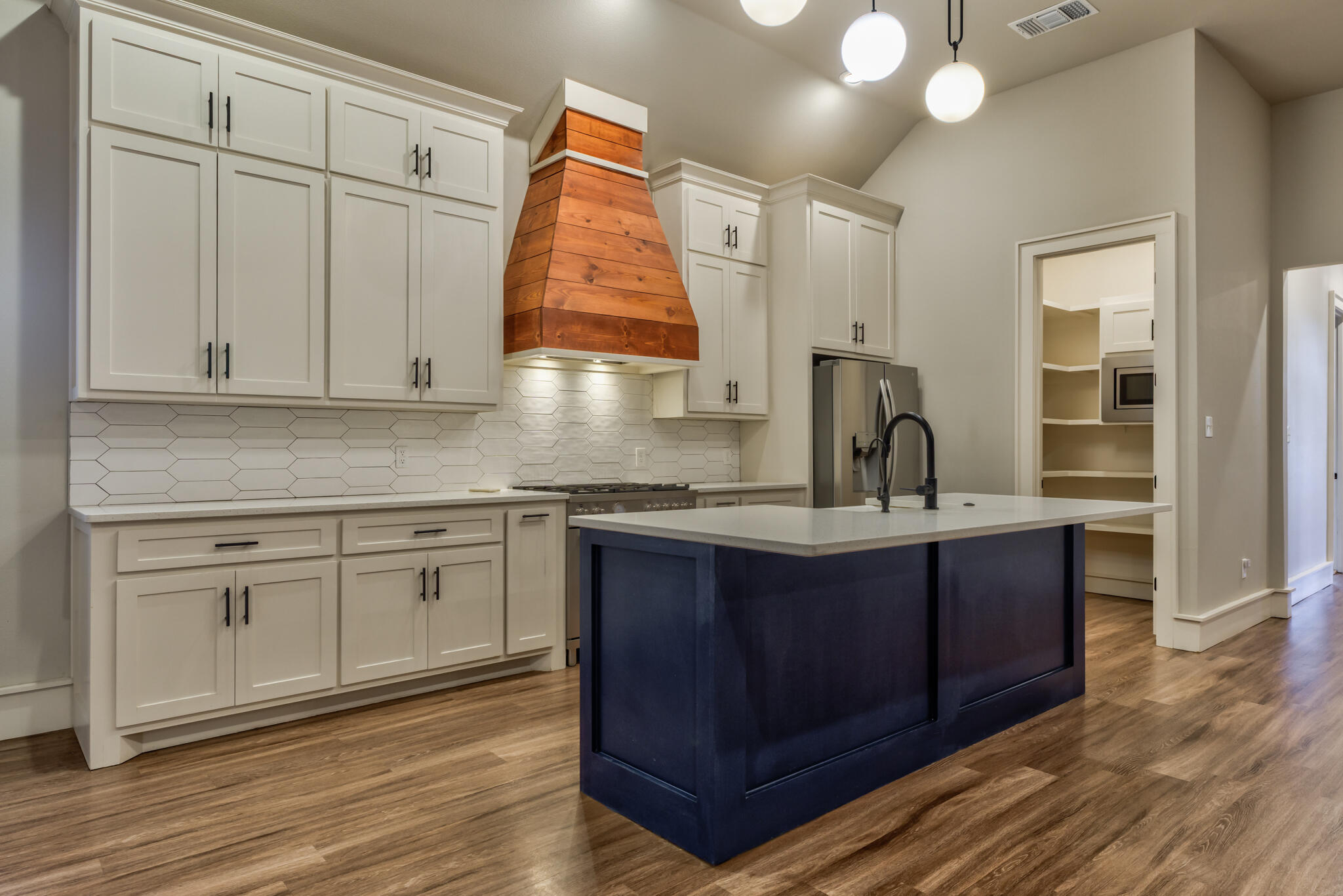 5303 110th Street Lubbock, TX 79424 - Photo 18 of 54 a kitchen with stainless steel appliances granite countertop a sink a stove and cabinets
