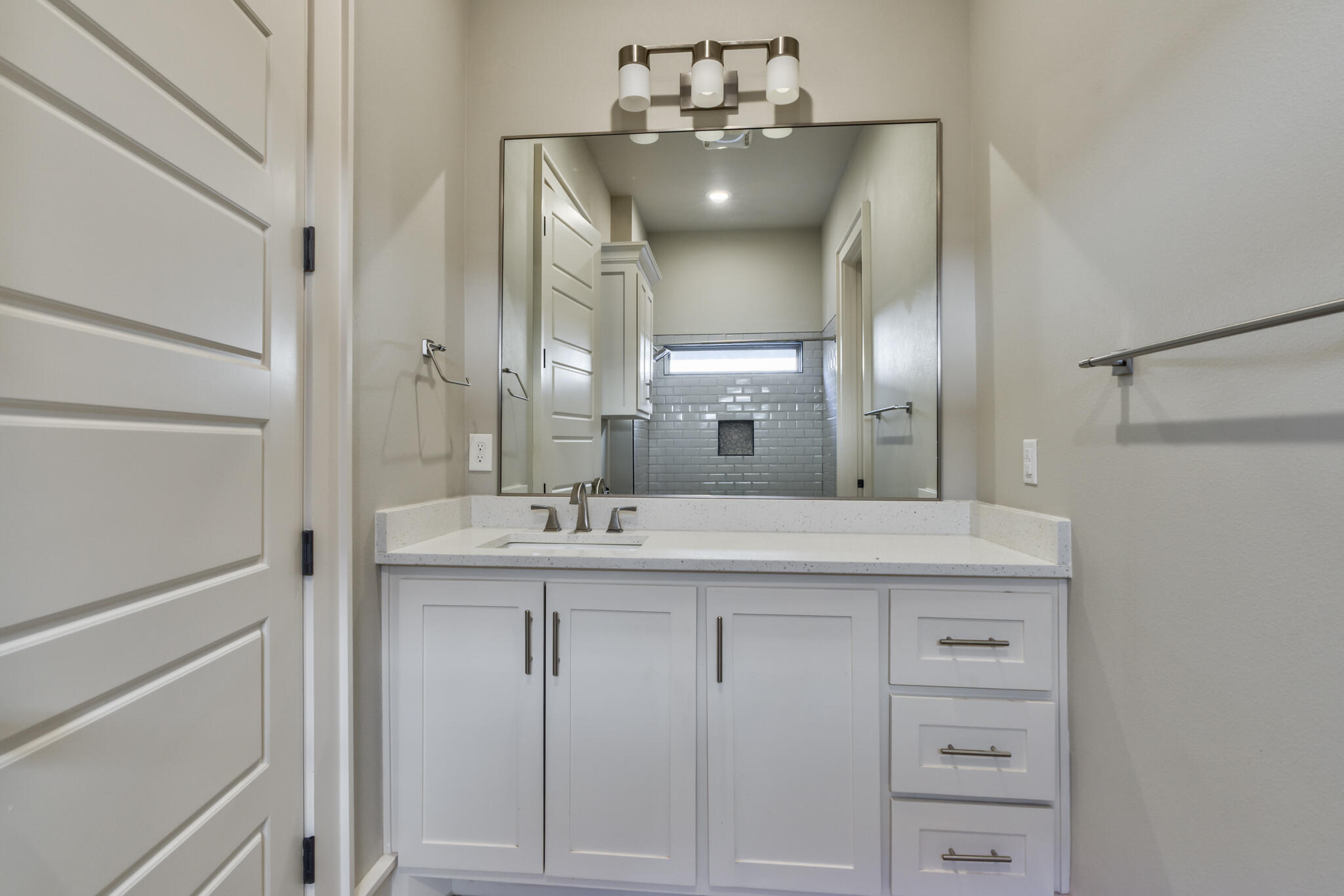 5303 110th Street Lubbock, TX 79424 - Photo 31 of 54 a bathroom with a sink and a mirror