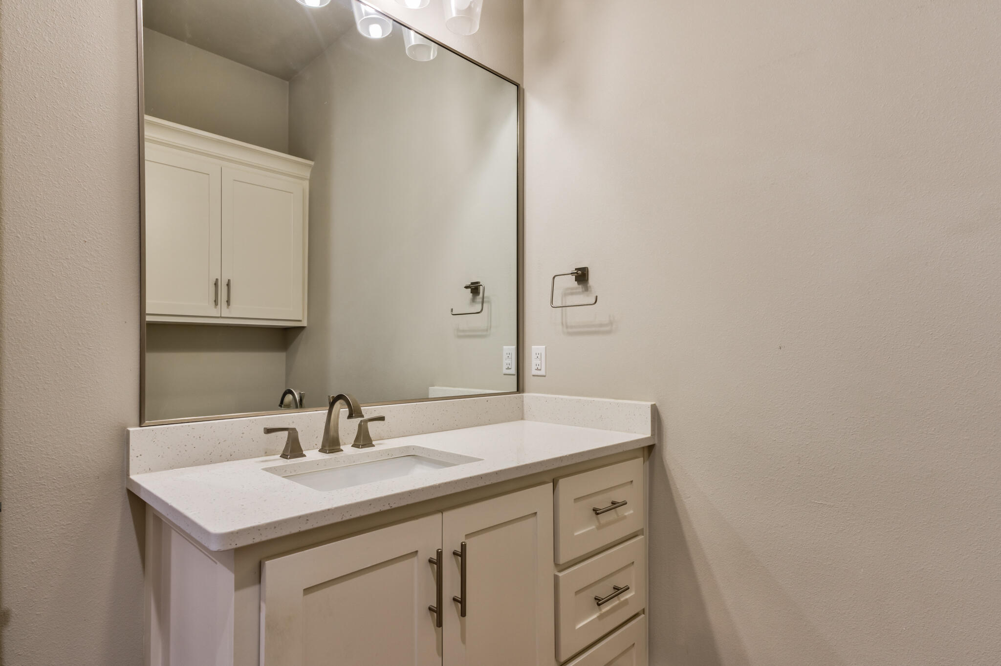 5303 110th Street Lubbock, TX 79424 - Photo 32 of 54 a bathroom with a sink and a mirror