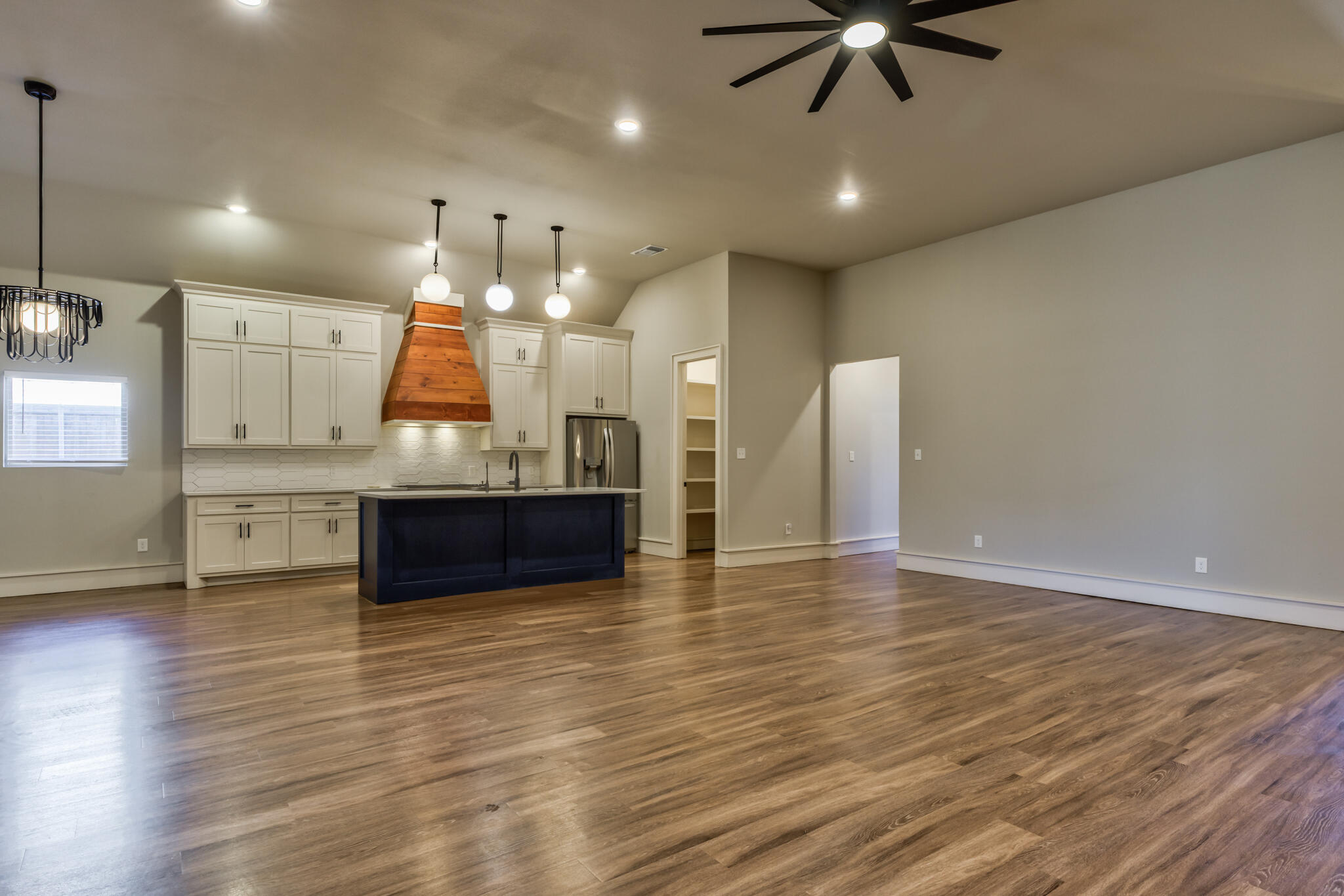 5303 110th Street Lubbock, TX 79424 - Photo 8 of 54 a view of kitchen and hall with wooden floor