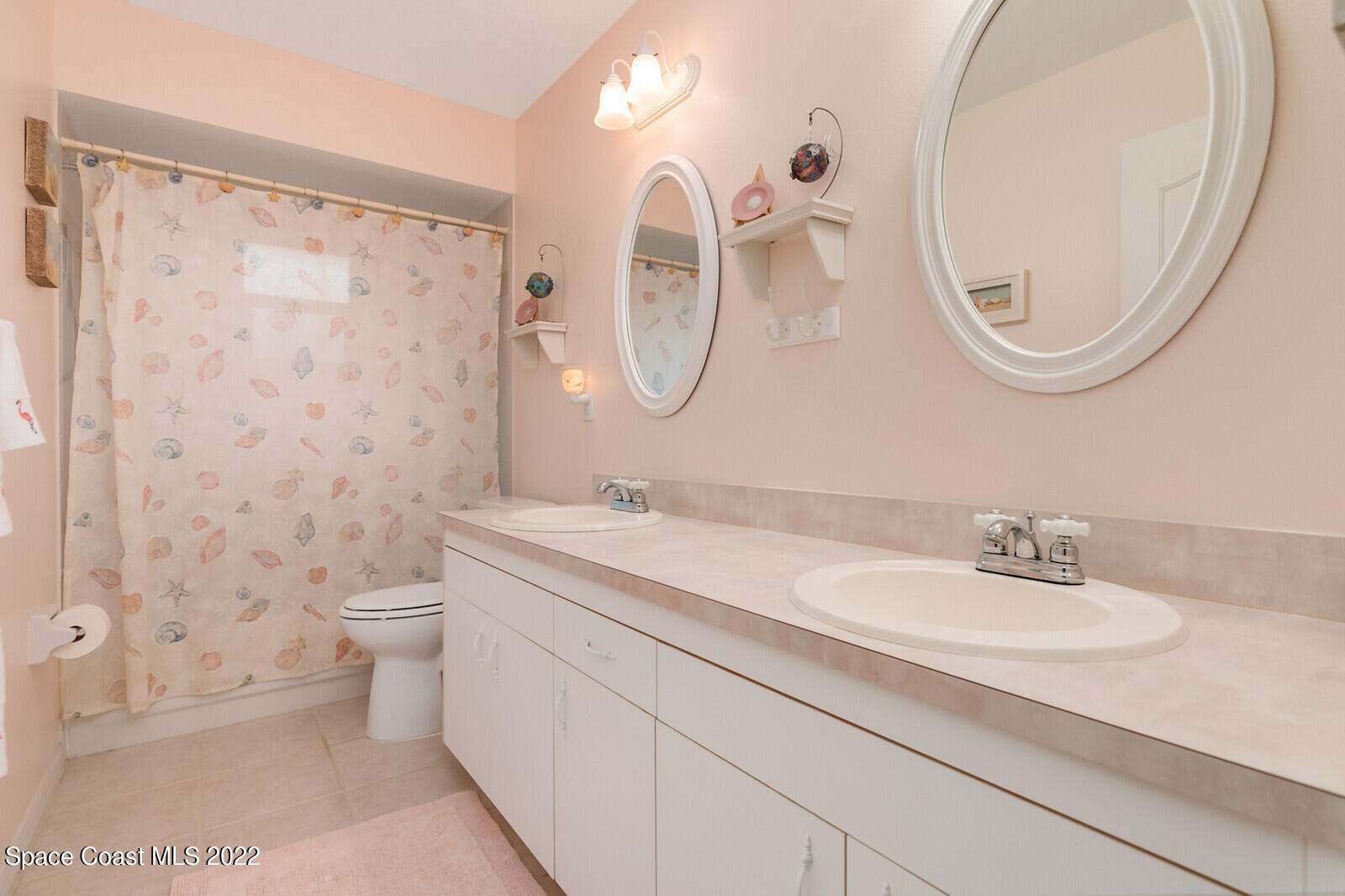 4885 Doreen Road Cocoa, FL 32927 - Photo 13 of 21 a bathroom with a granite countertop sink a toilet and a mirror