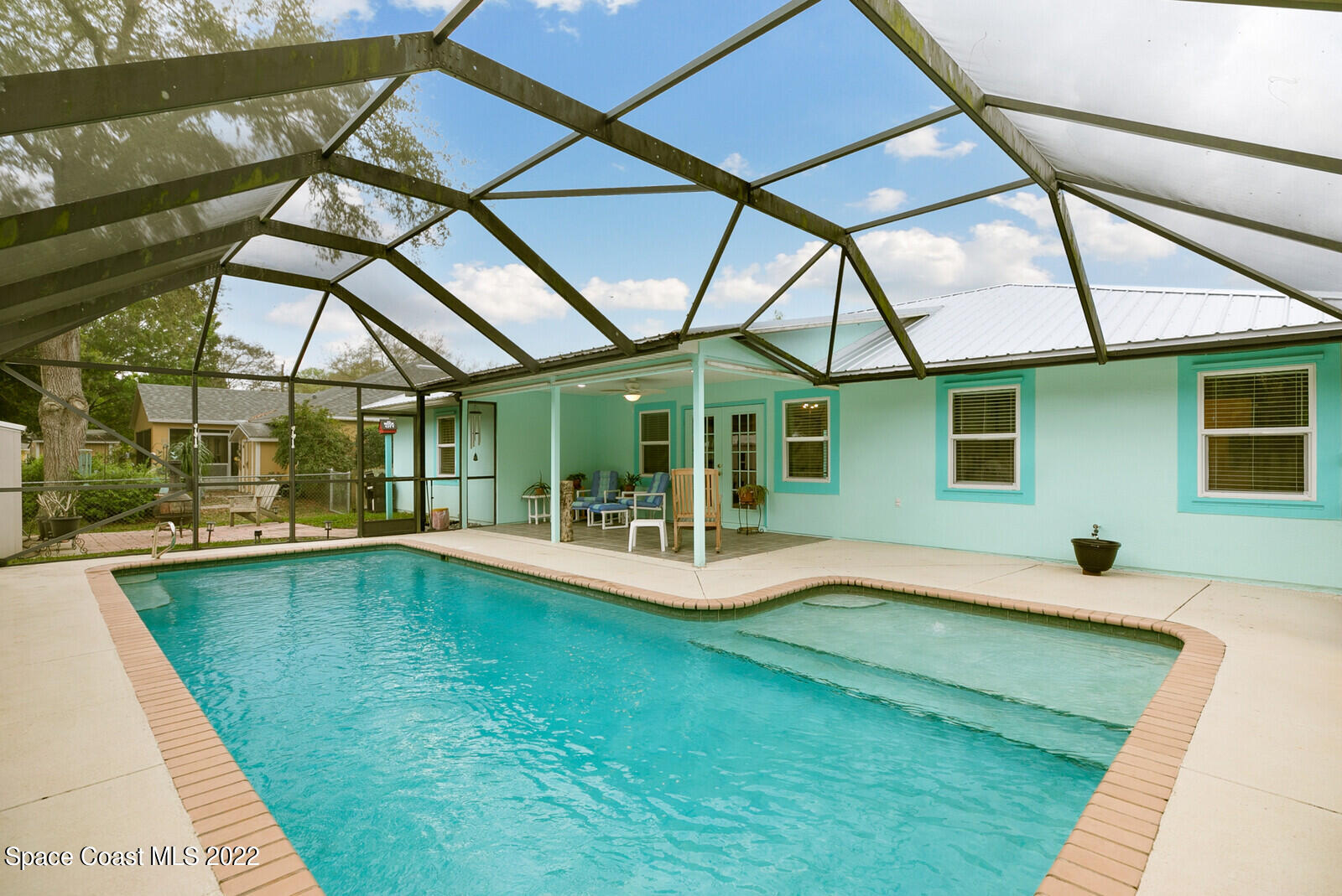 4885 Doreen Road Cocoa, FL 32927 - Photo 15 of 21 a view of house with swimming pool yard and outdoor seating