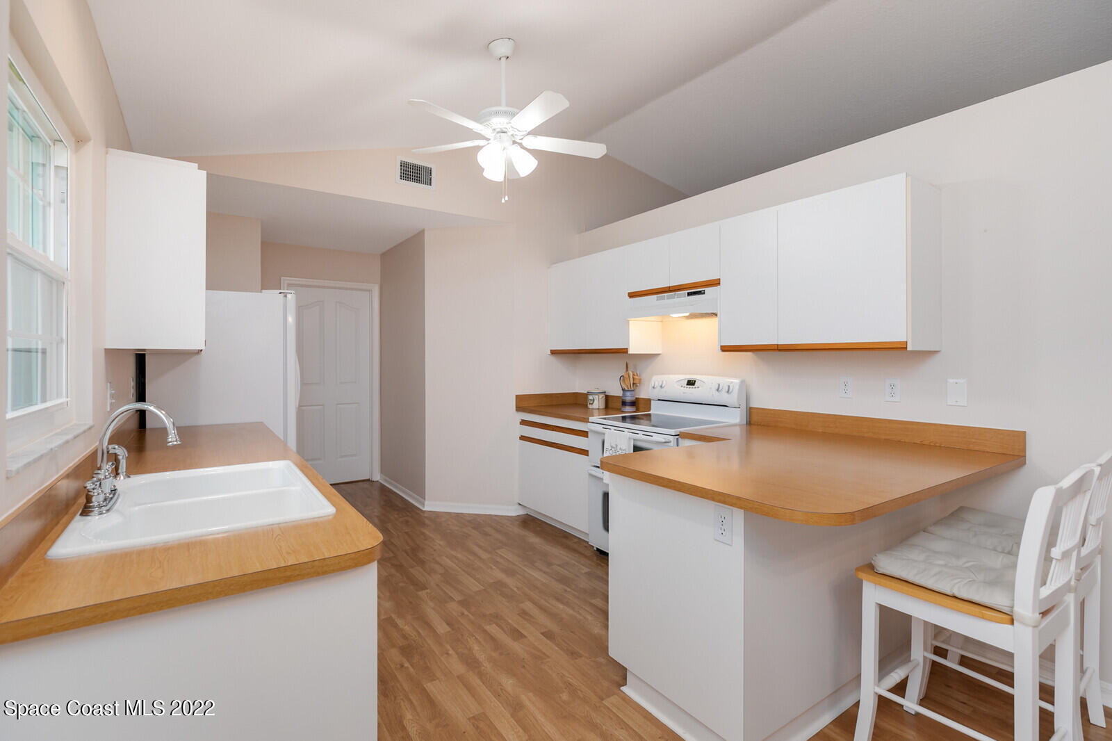 4885 Doreen Road Cocoa, FL 32927 - Photo 18 of 21 a kitchen with a stove a sink and a refrigerator
