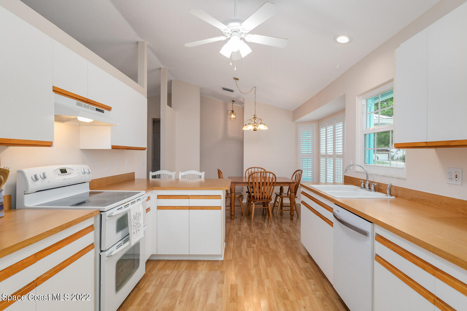 4885 Doreen Road Cocoa, FL 32927 - Photo 5 of 21 a kitchen that has a lot of cabinets a sink and appliances in it