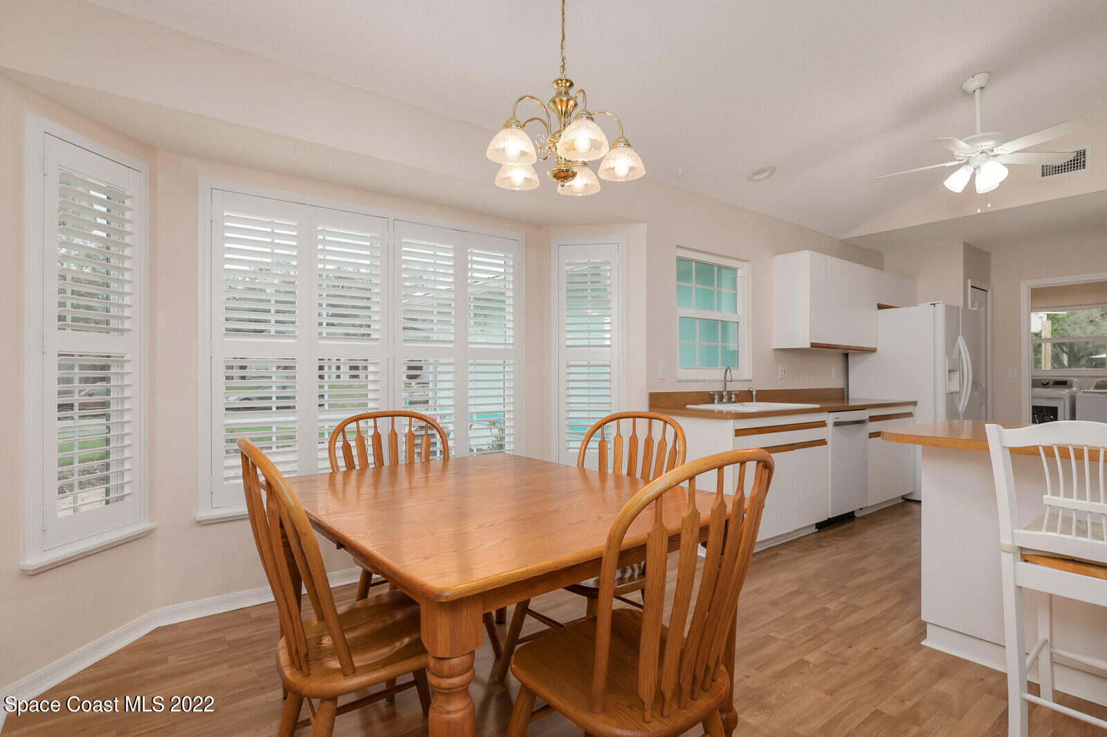 4885 Doreen Road Cocoa, FL 32927 - Photo 6 of 21 a dining room with furniture a chandelier and wooden floor