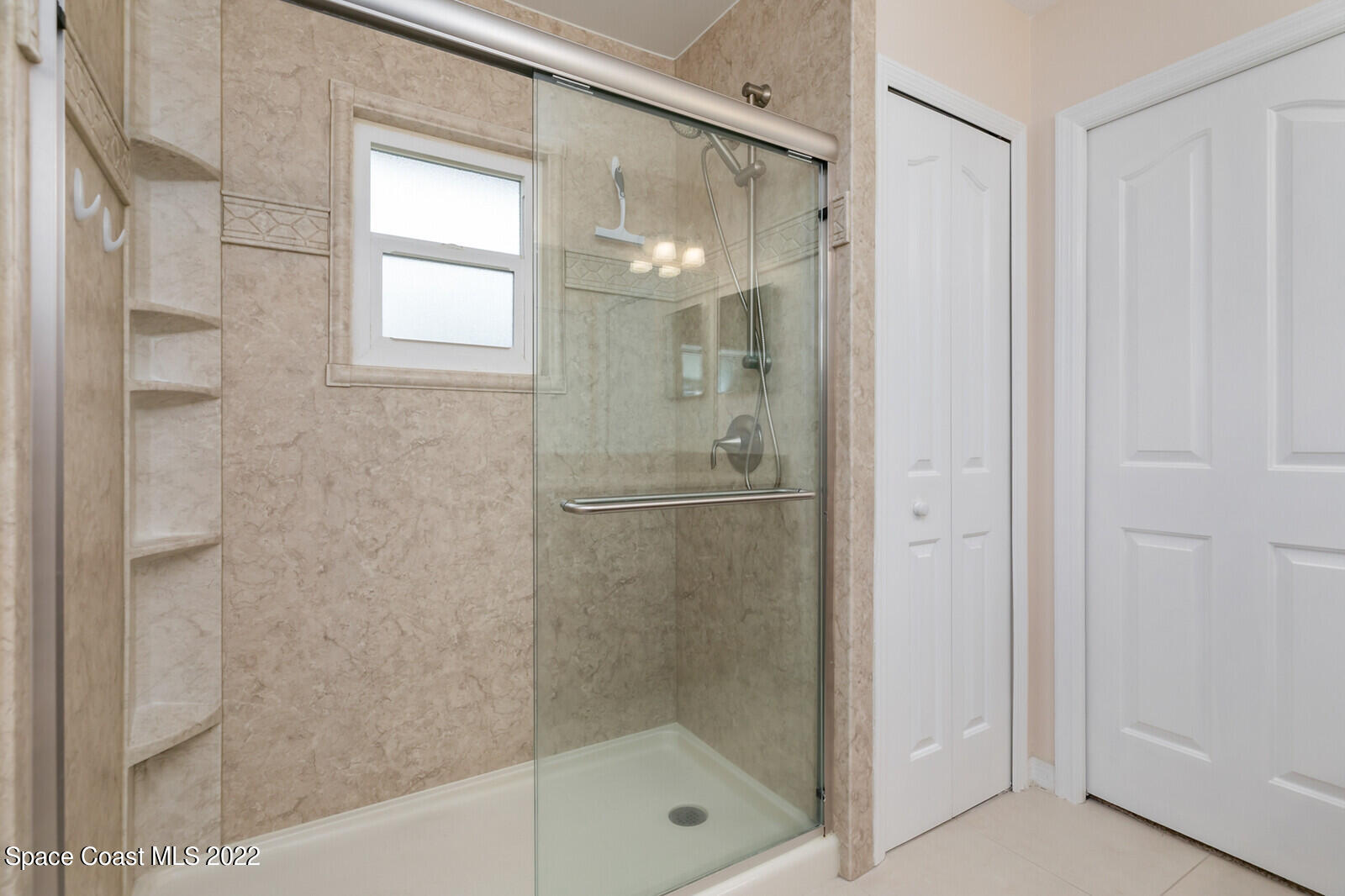 4885 Doreen Road Cocoa, FL 32927 - Photo 8 of 21 a bathroom with a glass shower door