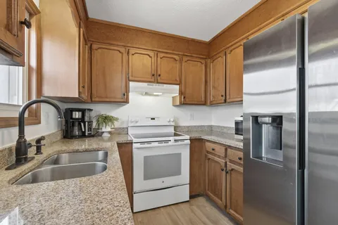 a kitchen with a sink stove and refrigerator