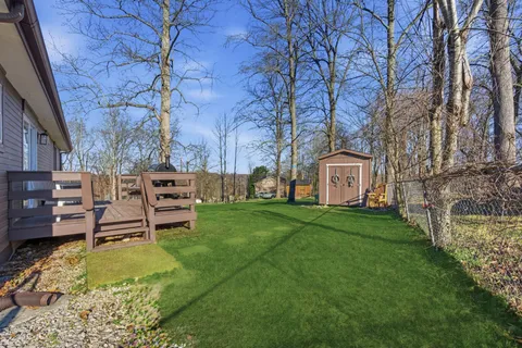 a view of a house with backyard and sitting area