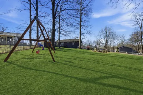 a view of an house with play ground and entertaining space