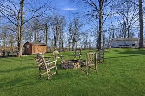 a wooden bench sitting in middle of a field